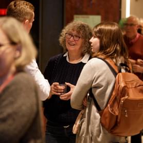Photograph of a group of friends talking and smiling