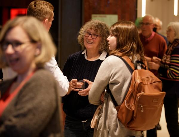 Photograph of a group of friends talking and smiling