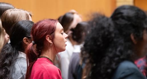 Photograph of a teenage girl singing in a Youth Chorus rehearsal