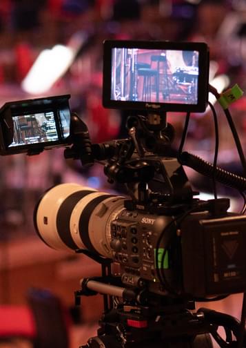 Photograph of a professional camera filiming a stage.