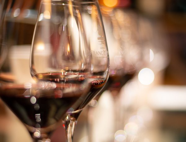 Photograph of red wine glasses.