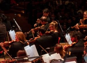 Photograph of the CBSO's violinists performing on-stage at Symphony Hall