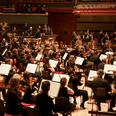Photograph of the orchestra performing on-stage at Symphony Hall