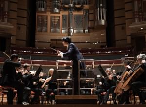 Photograph of Kazuki Yamada conducting the orchestra at Symphony Hall