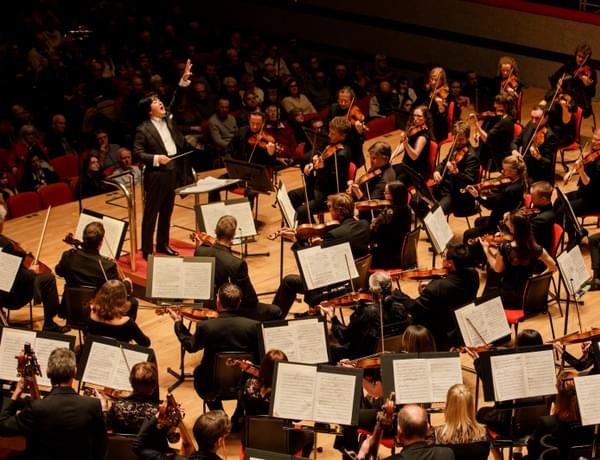 Photograph of Kazuki Yamada conducting the orchestra at Symphony Hall
