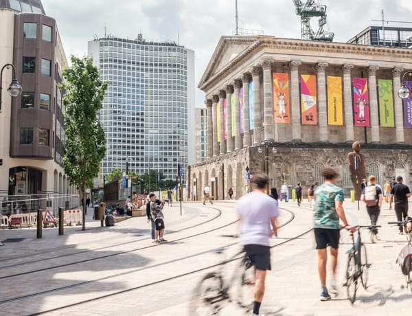 Photograph of Birmingham Town Hall with people standing around outside