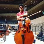 Photograph of Fabián Galeana holding a double bass