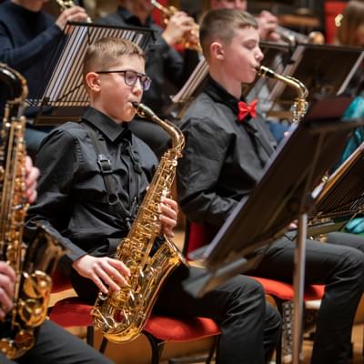 Photograph of a group of boys playing the saxophone