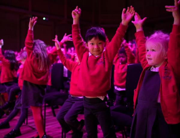 Photograph of a group of school children dancing together