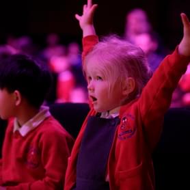 Photograph of a school child dancing at a performance