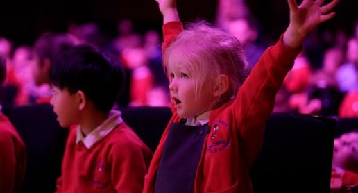 Photograph of a school child dancing at a performance