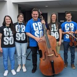 Photograph of CBSO musicians and staff smiling at the Shireland CBSO Academy's Instrument Fair.