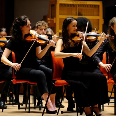 Photograph of violinists performing in the CBSO Youth Orchestra