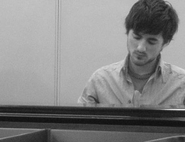Photograph of James Keefe playing the piano
