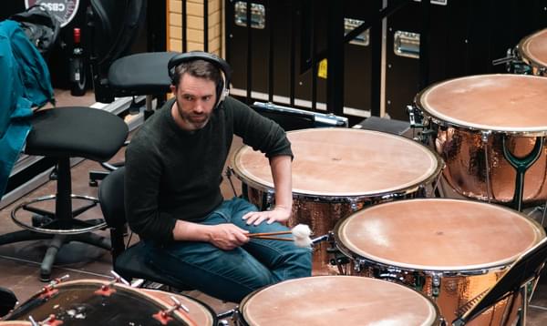 Photograph of Matthew Hardy wearing headphones during a recording session