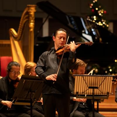 Photograph of Eugene Tzikindelean performing a violin solo