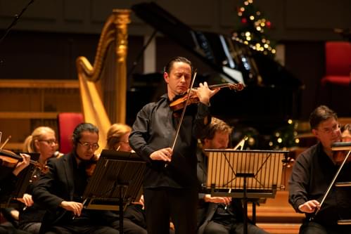 Photograph of Eugene Tzikindelean performing a violin solo