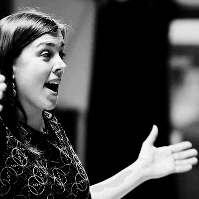 Black and white photograph of Lucy Hollins conducting