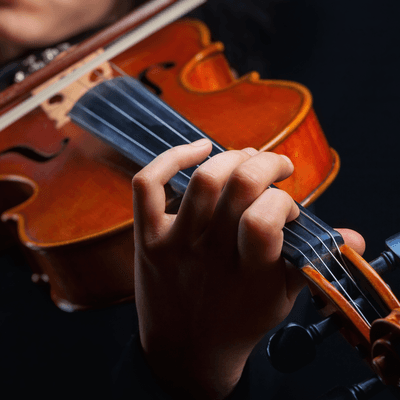 Close-up photograph of a violinist's hands as they play