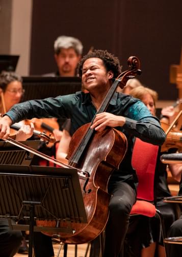 Photograph of Sheku Kanneh-Mason playing the cello with the CBSO at Symphony Hall.