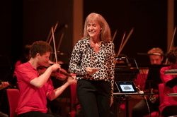 Photograph of Catherine Arldige presenting a family concert.