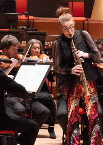 Jess Gillam playing the saxophone with the CBSO