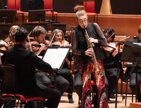 Jess Gillam playing the saxophone with the CBSO